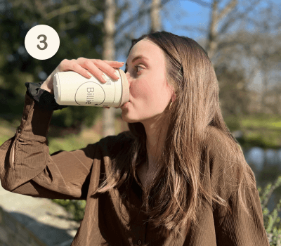 Régalez-vous ! Fille qui boit dans un gobelet réutilisable